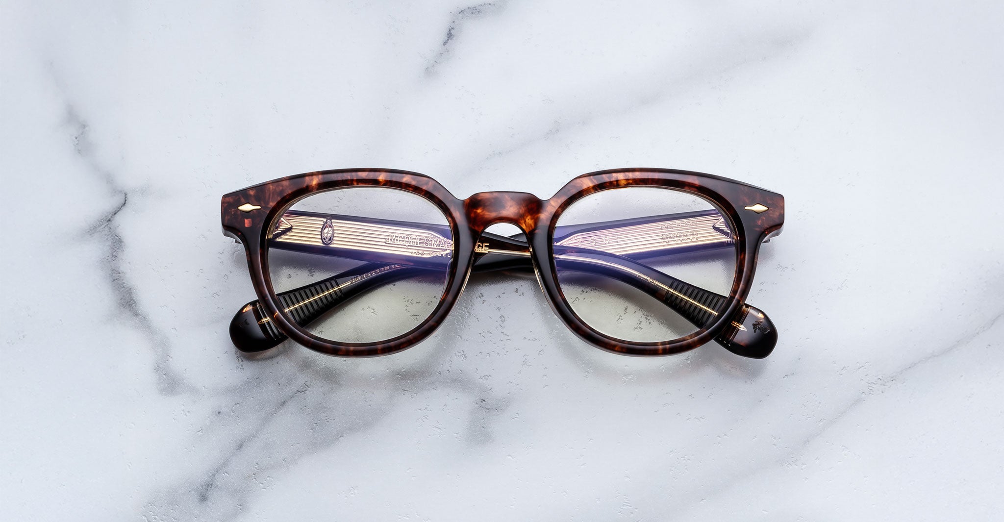 Jacques Marie Mage Matsu tortoiseshell eyeglasses with folded arms viewed from above.