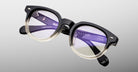 Jacques Marie Mage Matsu eyeglasses with round black and clear acetate frames, front view.