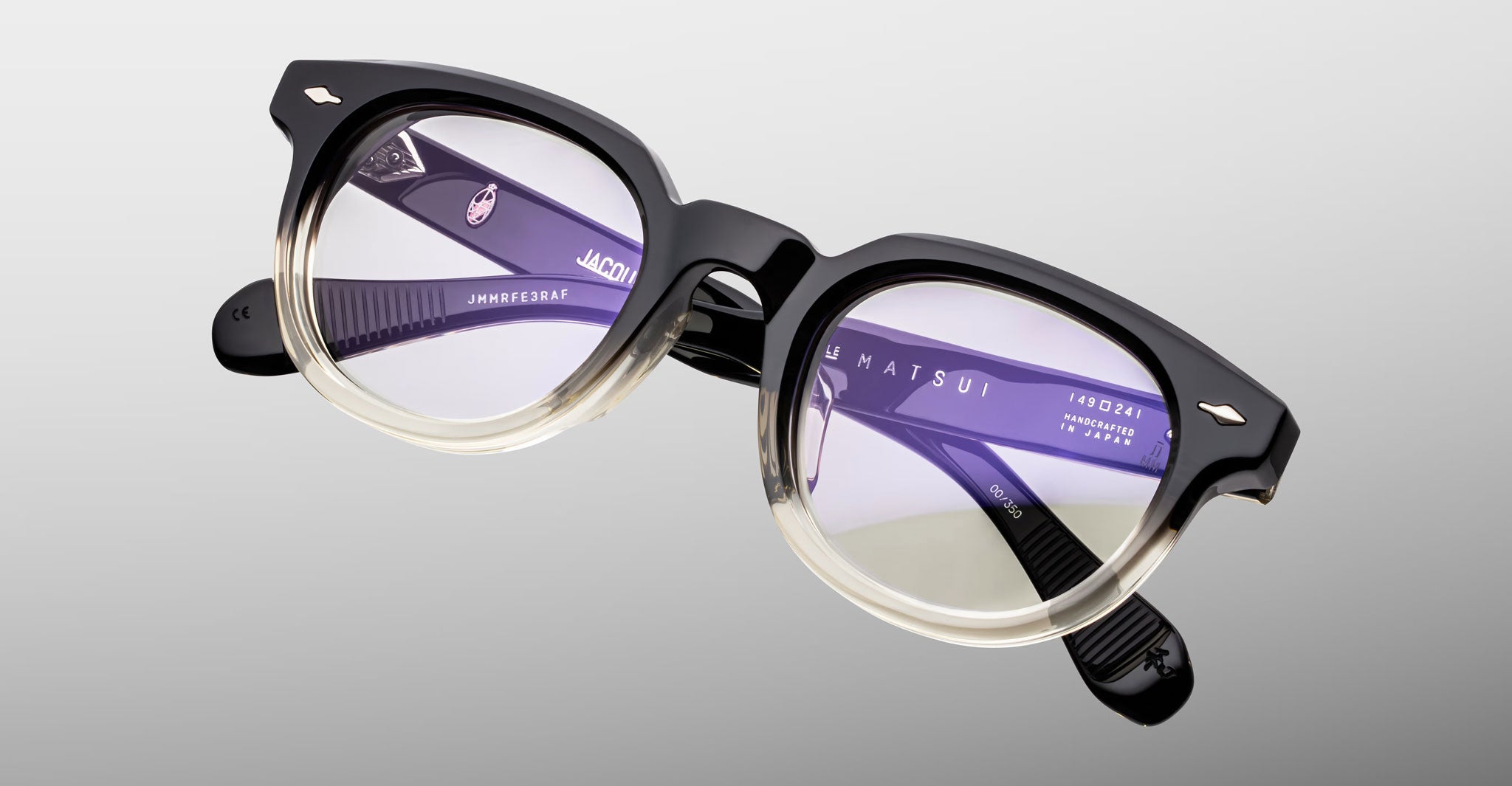 Jacques Marie Mage Matsu eyeglasses with round black and clear acetate frames, front view.