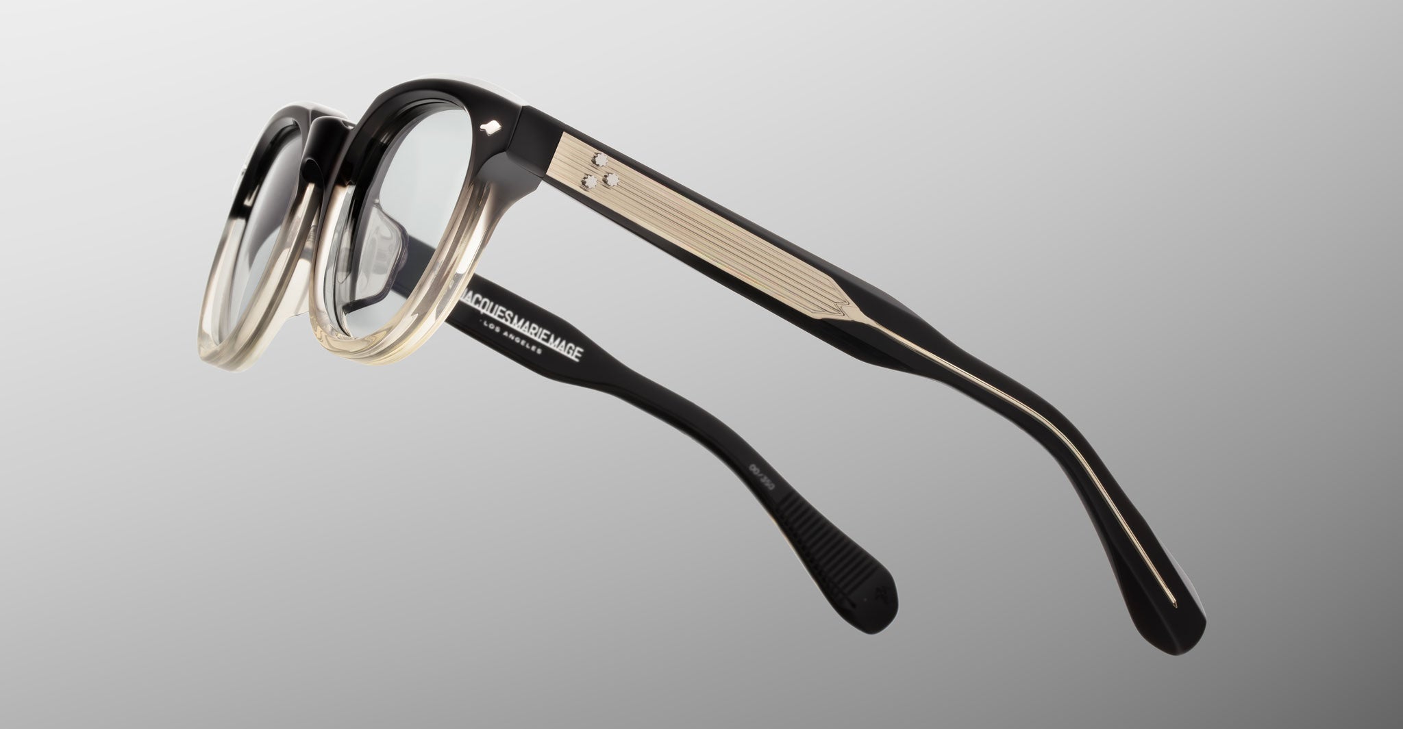 Jacques Marie Mage Matsu eyeglasses, black and beige acetate with clear lenses, shown from the side angle.