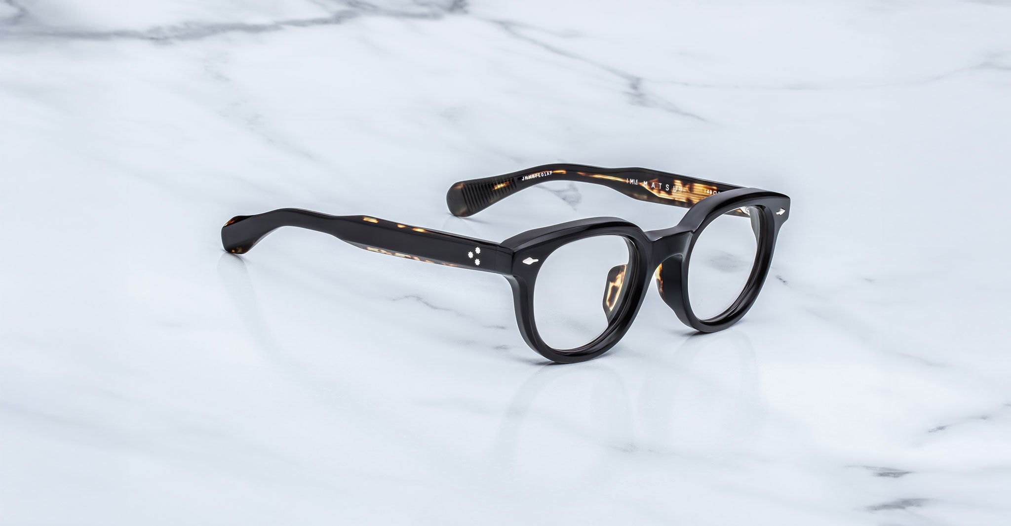 Jacques Marie Mage Matsu round eyeglasses displayed from above; clear lenses and full frame design are visible.