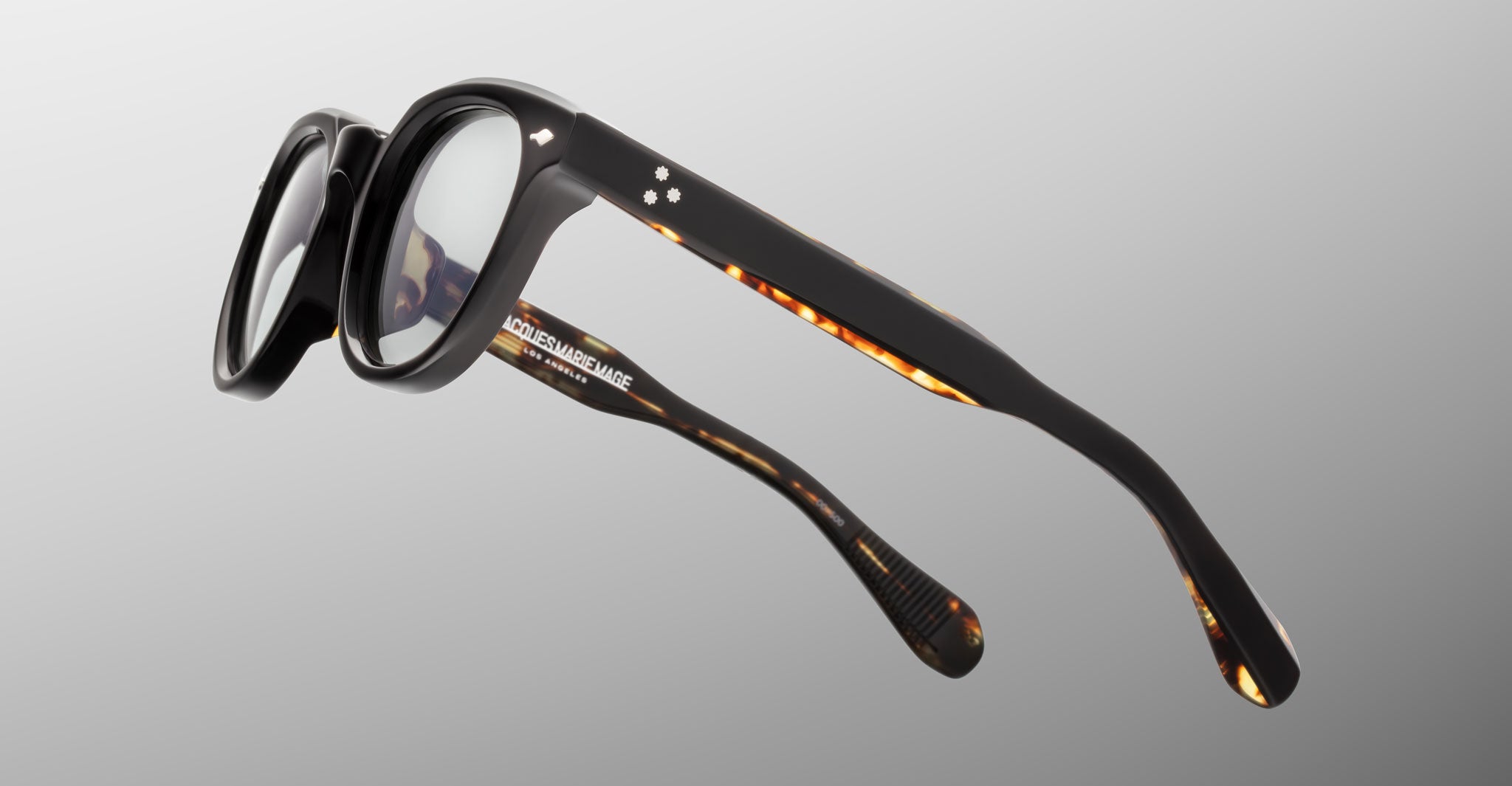 Jacques Marie Mage Matsu round eyeglasses, black and tortoiseshell frame, side view.