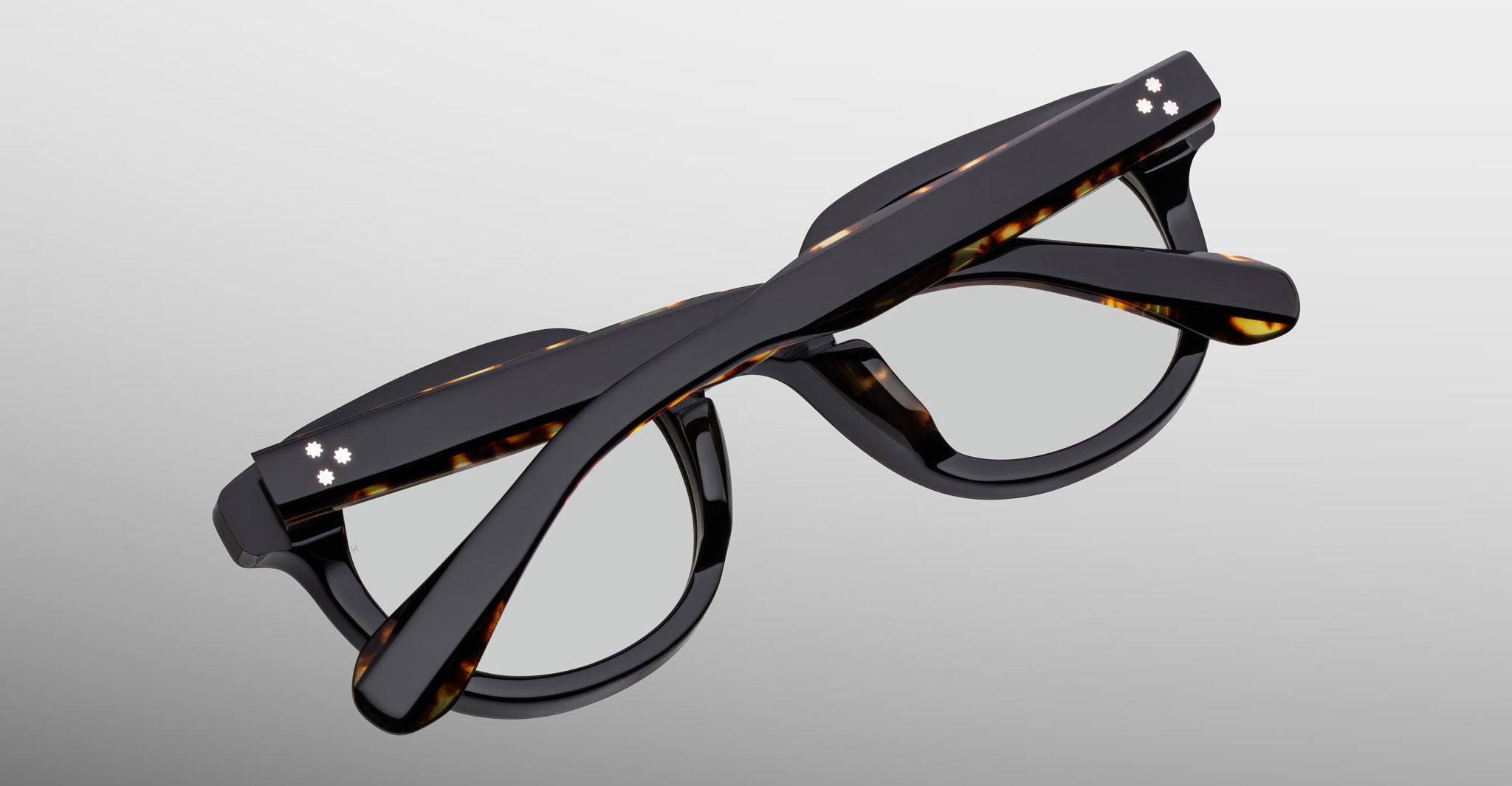 Jacques Marie Mage Matsu eyeglasses, black tortoiseshell acetate frames, folded, top view.