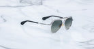 Jacques Marie Mage Maxime aviator sunglasses with silver frame, dark polarized lenses, and black arms, front view.