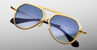 Jacques Marie Mage Maxime aviator sunglasses in gold with blue lenses and black polarized arms, shown from the front angle.