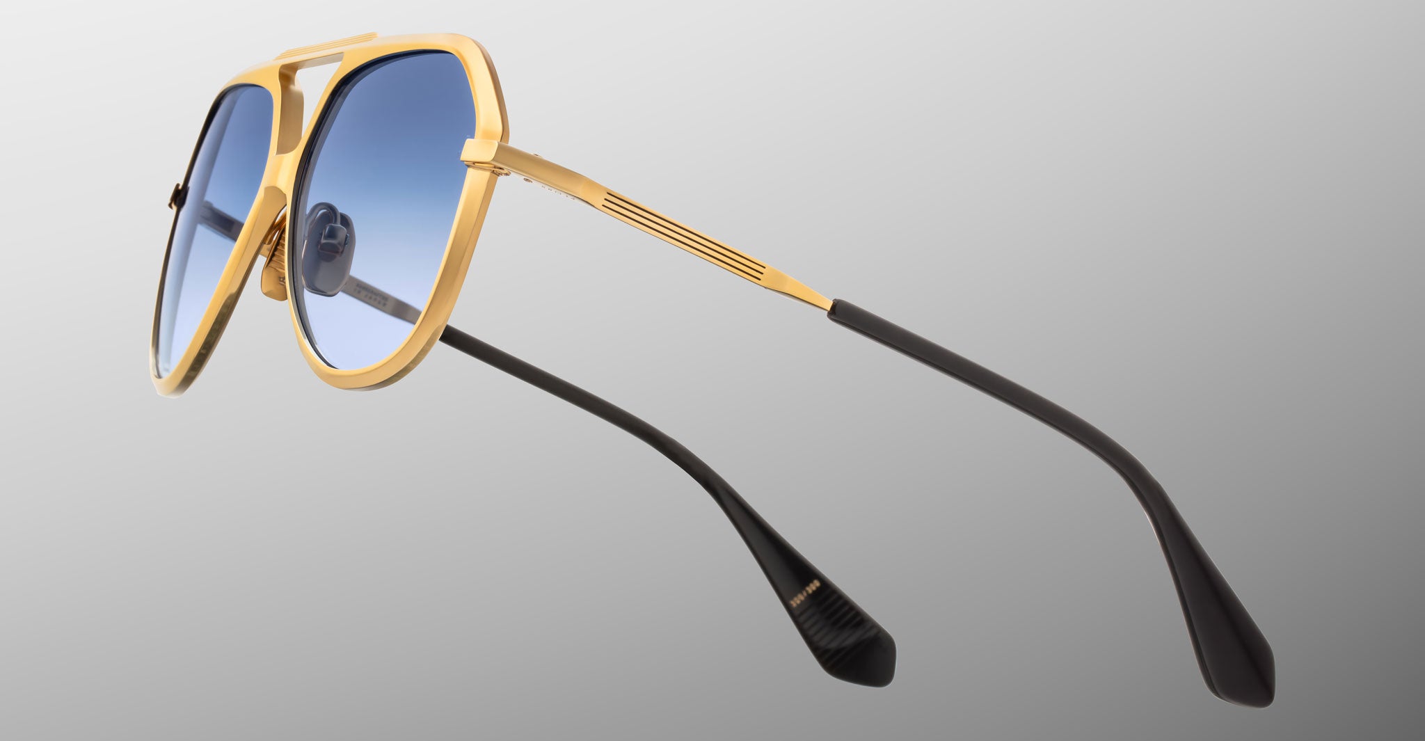 Jacques Marie Mage Maxime sunglasses, gold frame, blue gradient lenses, black arms, front view.