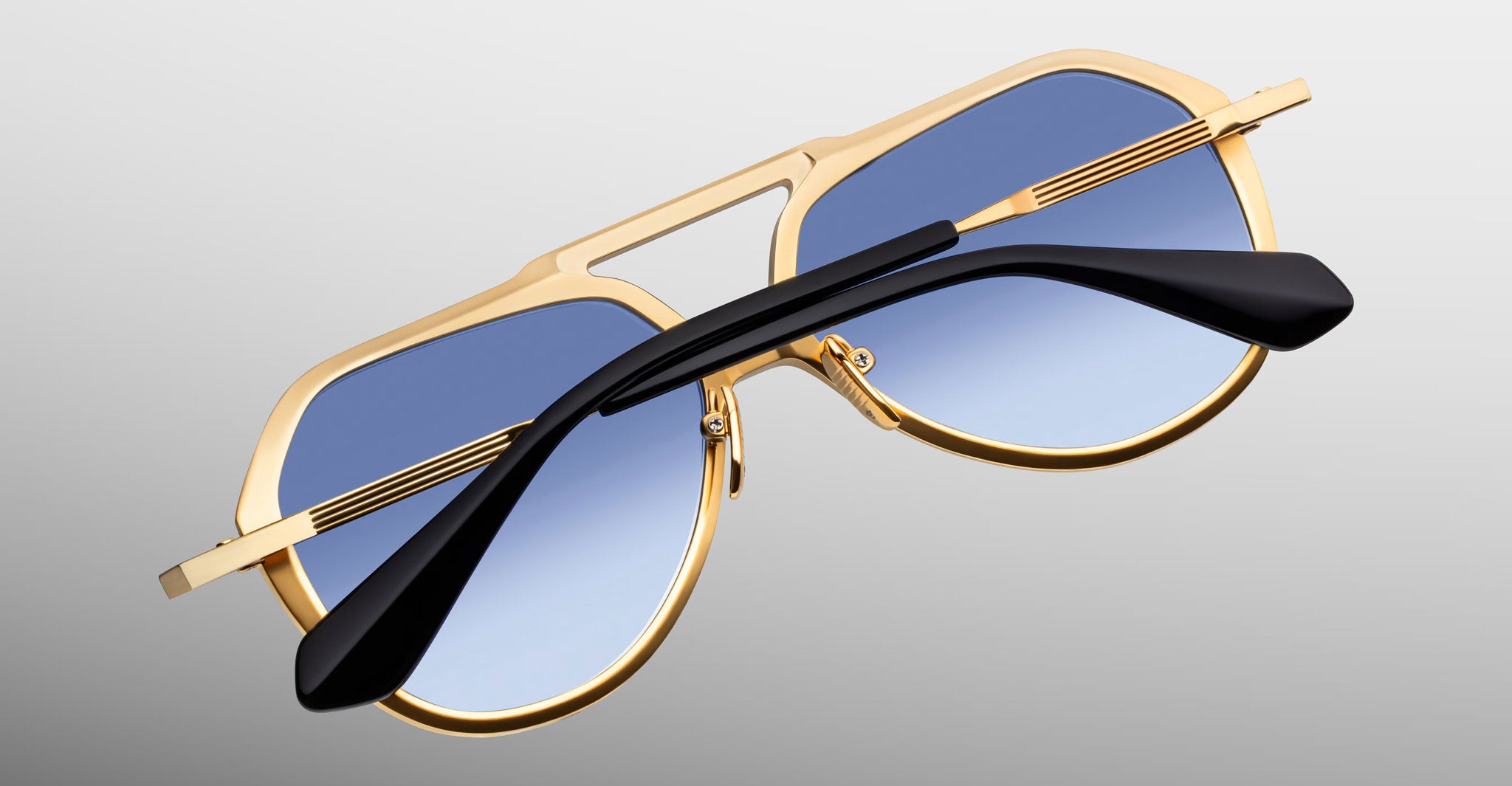 Jacques Marie Mage Maxime aviator sunglasses in gold with blue gradient lenses and black arms, front view.