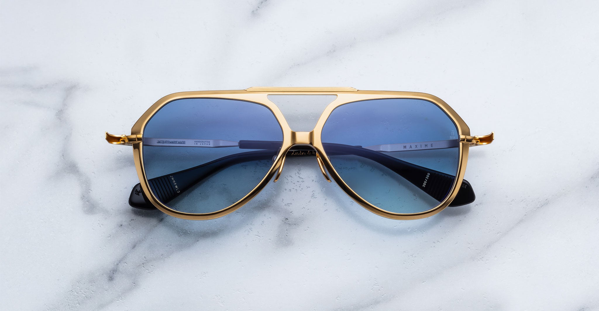 Jacques Marie Mage Maxime gold aviator sunglasses with blue lenses, front angle view.
