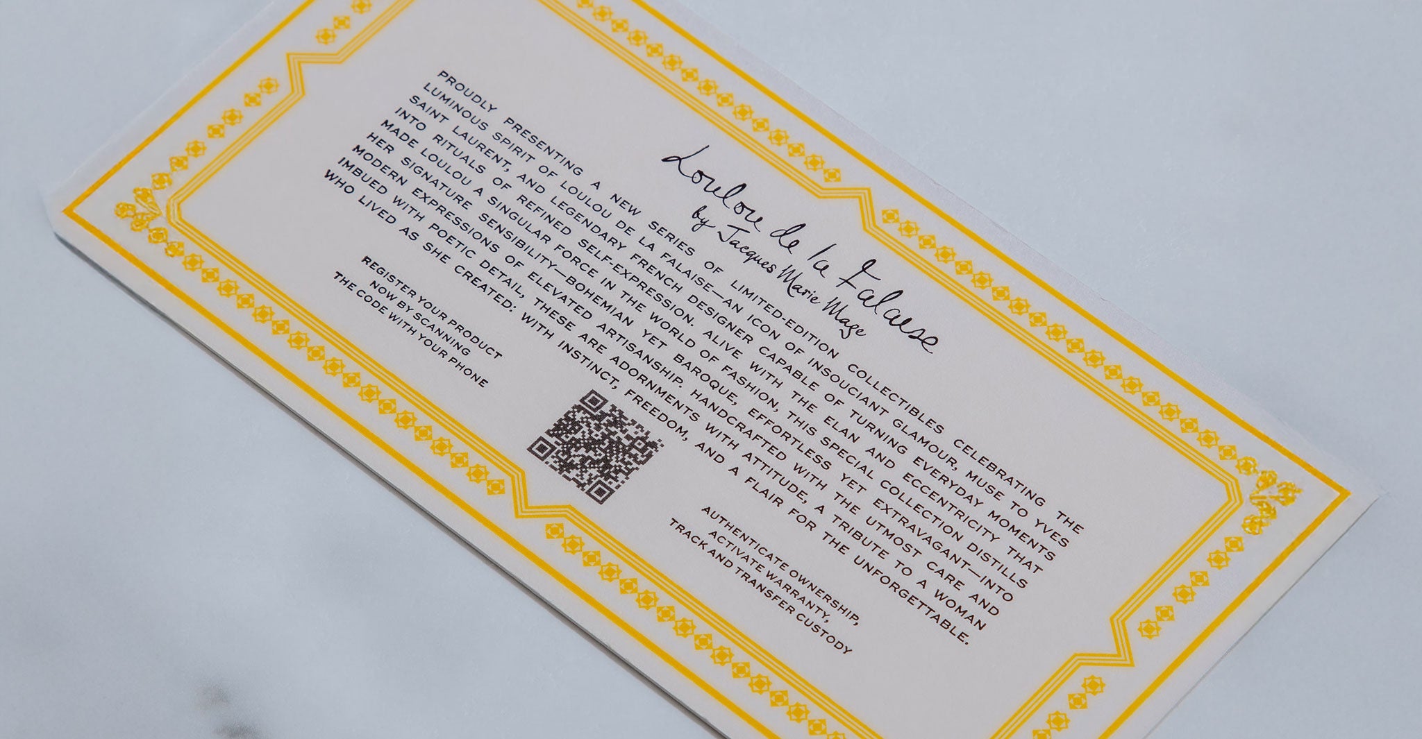 Rectangular Jacques Marie Mage Maxime eyeglasses card with yellow border, handwritten and printed text, QR code, top view.