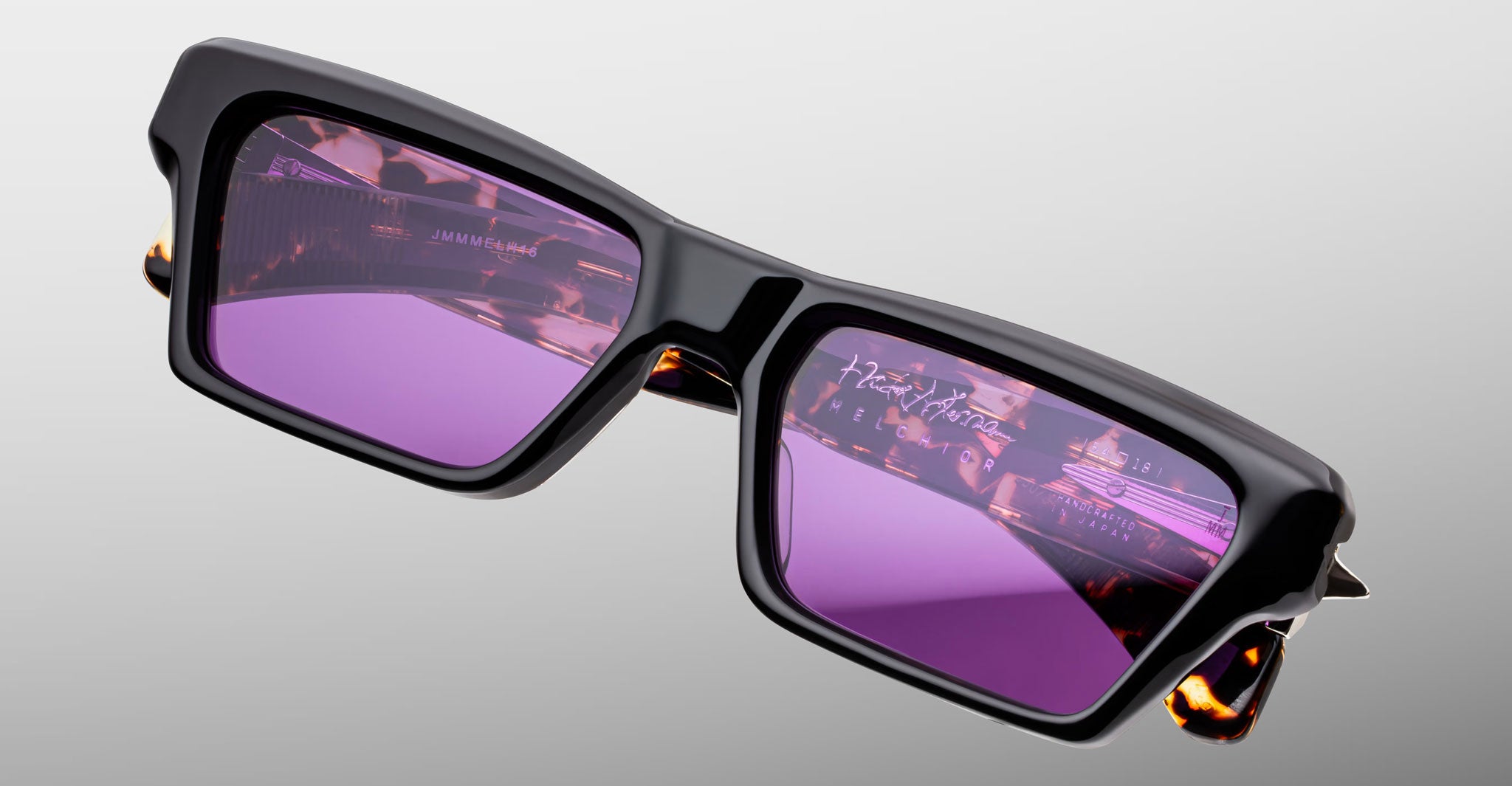 Jacques Marie Mage Melchior sunglasses, black rectangular frames with purple lenses, front view.