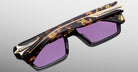 Jacques Marie Mage Melchior rectangular sunglasses with purple lenses, thick tortoiseshell frames, and gold accents, front view.