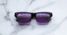 Jacques Marie Mage Melchior black rectangular sunglasses with purple lenses, front view.