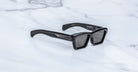 Jacques Marie Mage Melchior sunglasses, black rectangular frames with thick acetate and UV lenses, shown from the front.