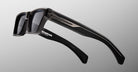 Jacques Marie Mage Melchior sunglasses, black rectangular frames with thick temples and silver accents, shown from the front angle.