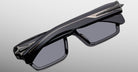 Jacques Marie Mage Melchior sunglasses, front view; black rectangular frames with thick angular design and dark UV lenses.