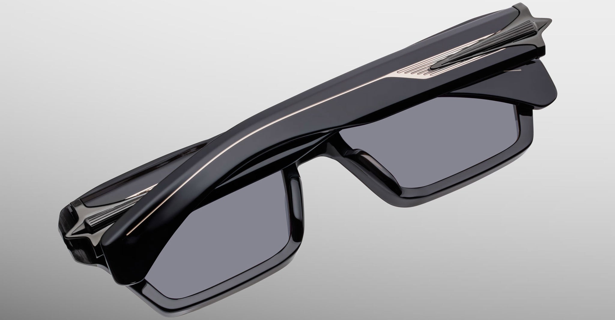 Jacques Marie Mage Melchior sunglasses, front view; black rectangular frames with thick angular design and dark UV lenses.