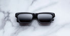 Jacques Marie Mage Melchior black rectangular sunglasses with dark lenses, top view.