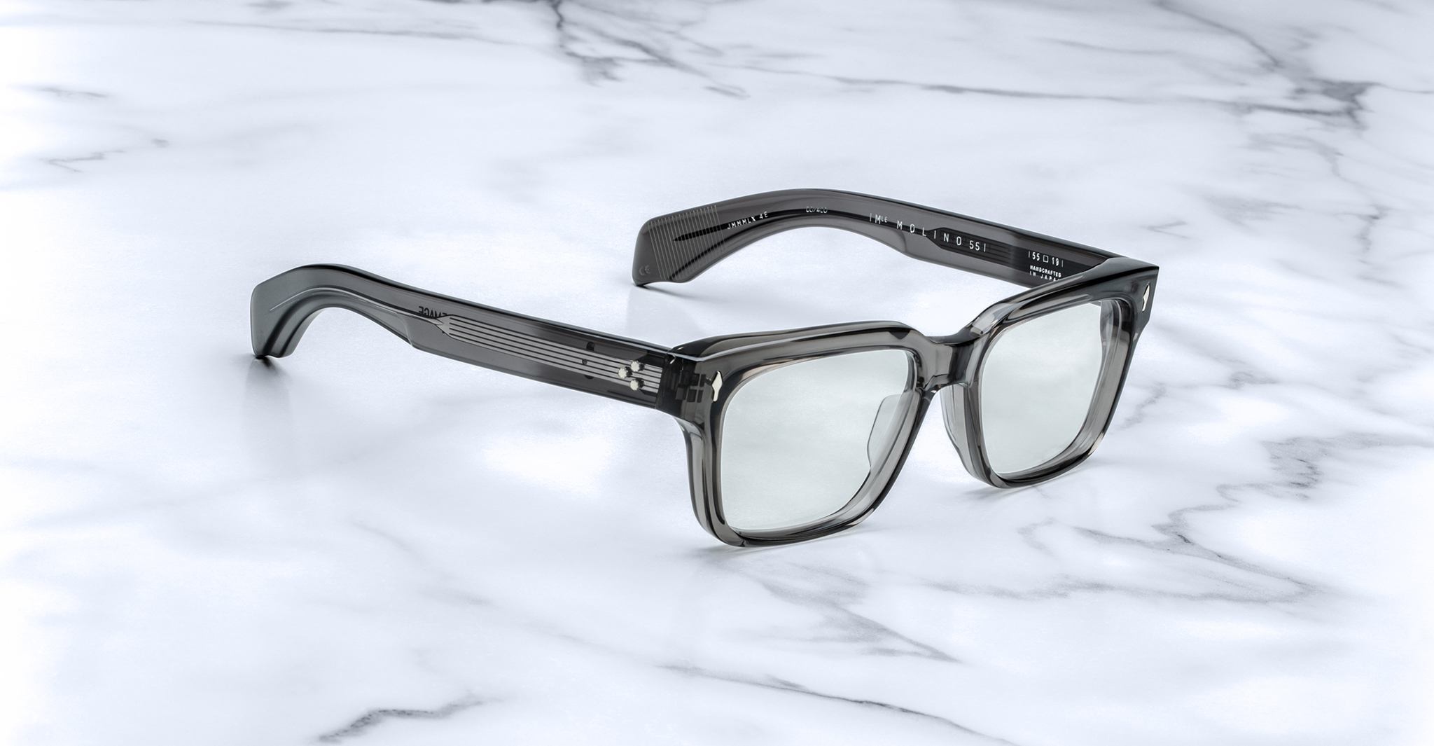 Jacques Marie Mage Molino 55 square gray eyeglasses with acetate arms, viewed from above, display on surface.
