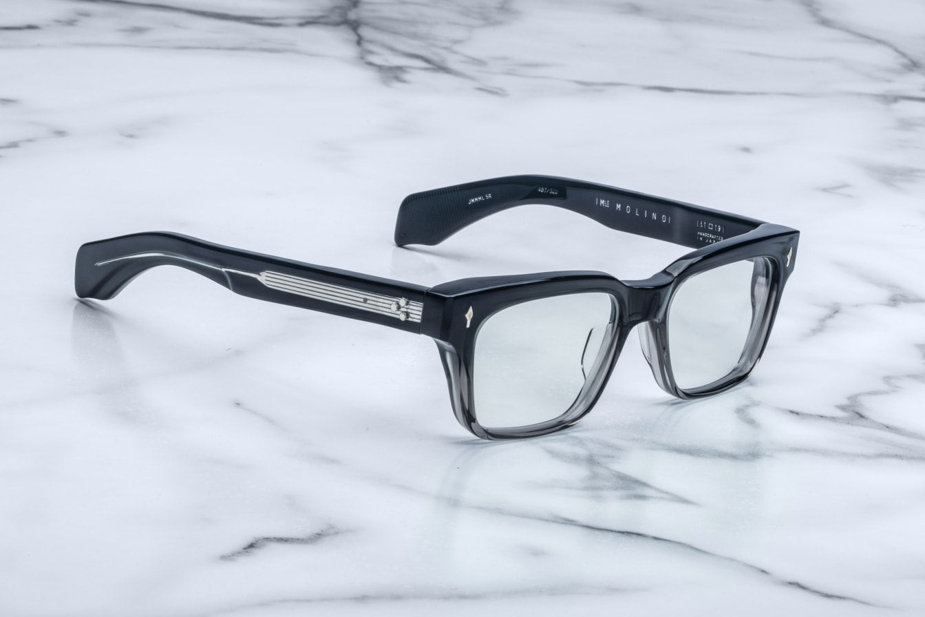 Jacques Marie Mage Molino black rectangular eyeglasses with silver accents, shown from above.