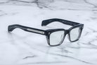 Jacques Marie Mage Molino black rectangular eyeglasses with silver accents, shown from above.