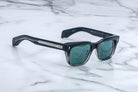 Jacques Marie Mage Walker black rectangular sunglasses with green lenses, UV protection, shown from above.