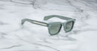 Jacques Marie Mage Molino gray rectangular sunglasses with thick frames and metal accents, shown from above.
