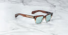 Jacques Marie Mage Molino square sunglasses with UV-protective light blue lenses, front view.