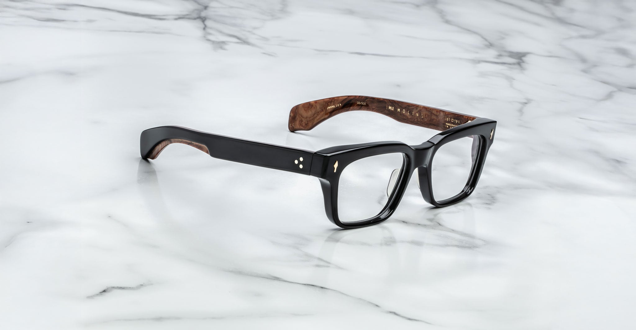 Jacques Marie Mage Molino black rectangular eyeglasses with wood-patterned temples, shown from above.