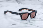 Jacques Marie Mage Molino black rectangular sunglasses with brown lenses and tortoiseshell inner arms, front view.