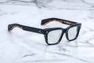 Jacques Marie Mage Molino black rectangular sunglasses with semi-reflective lenses, front view.
