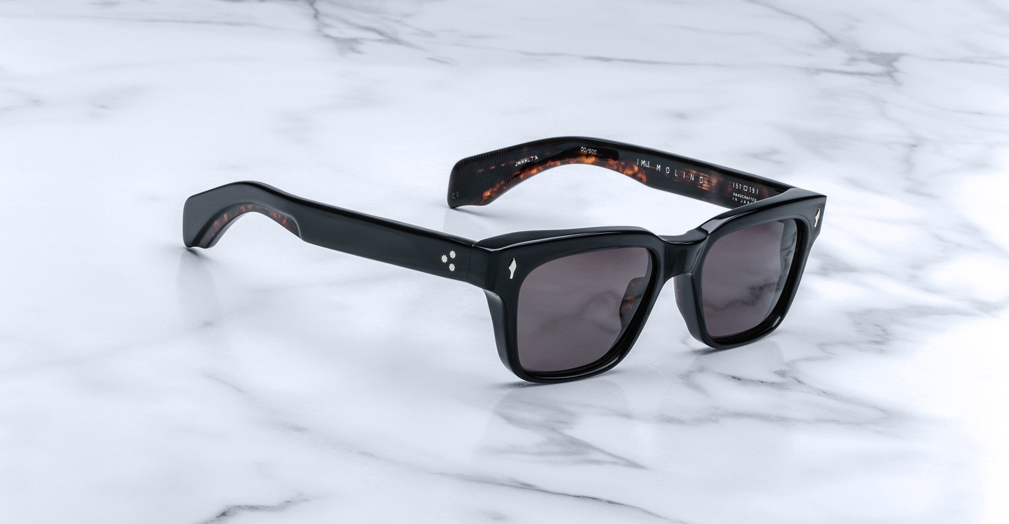 Jacques Marie Mage Molino black rectangular sunglasses with thick frames and UV lenses, front view.