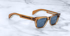 Jacques Marie Mage Molino sunglasses with brown frames and polarized blue lenses, front view.