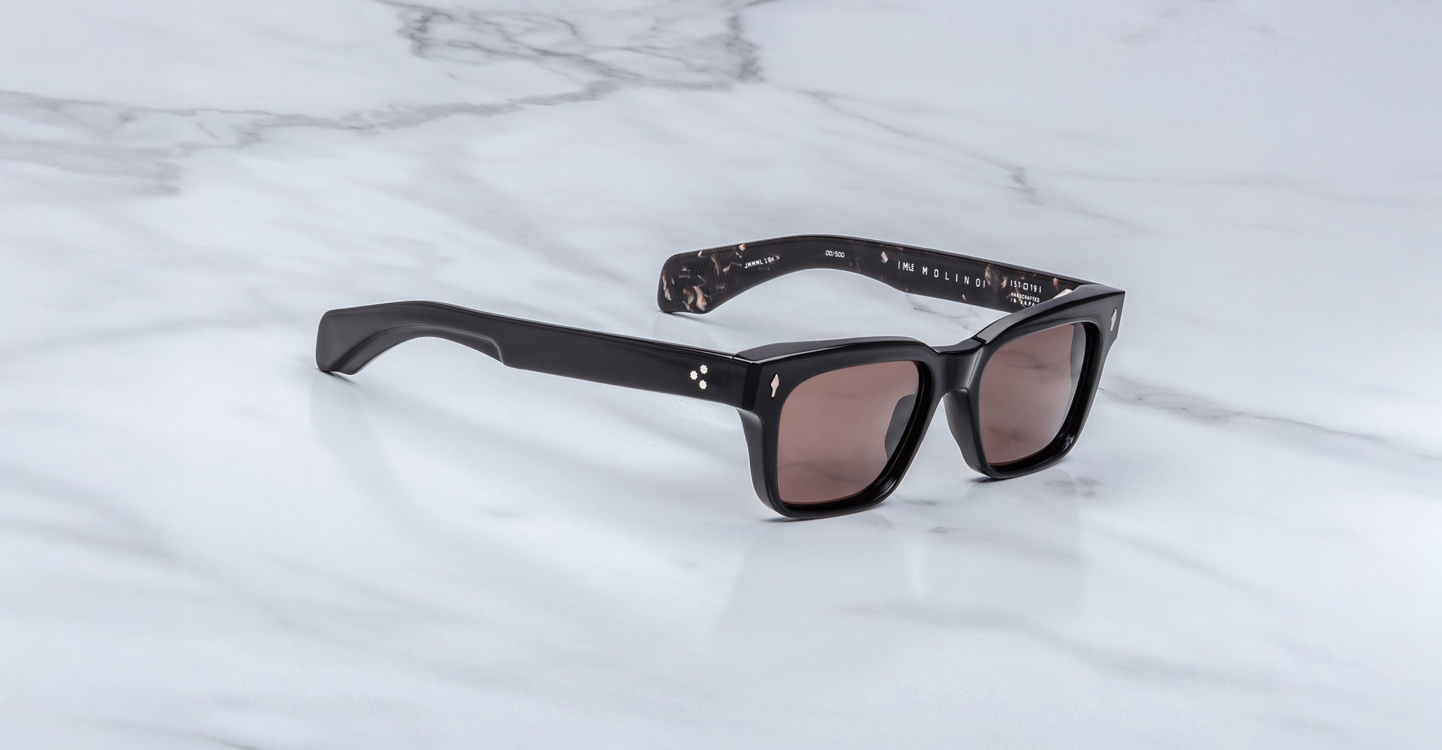 Jacques Marie Mage Molino black rectangular sunglasses with UV-protective lenses, shown from above.