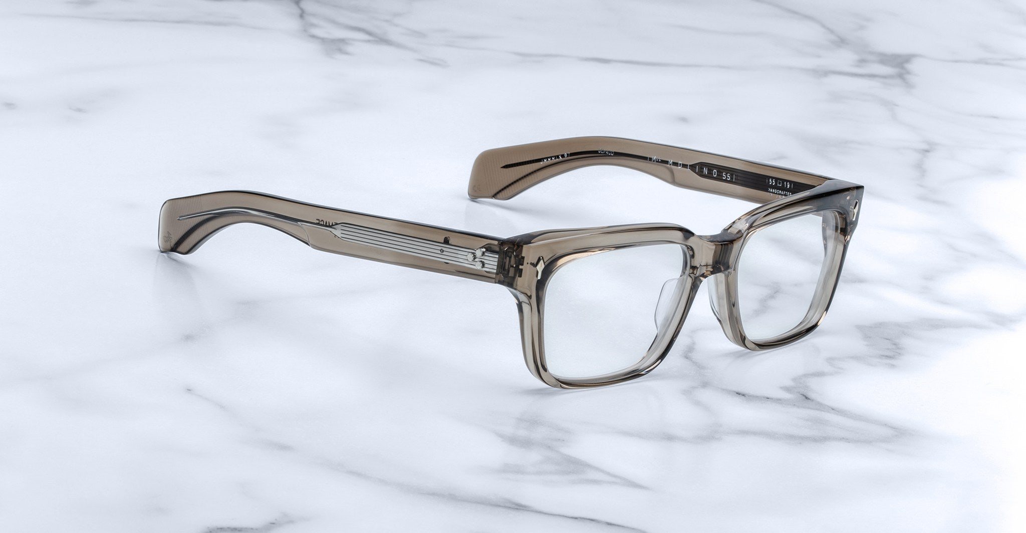 Jacques Marie Mage Molino 55 thick-rimmed rectangular eyeglasses, front view, displayed on a marble surface.