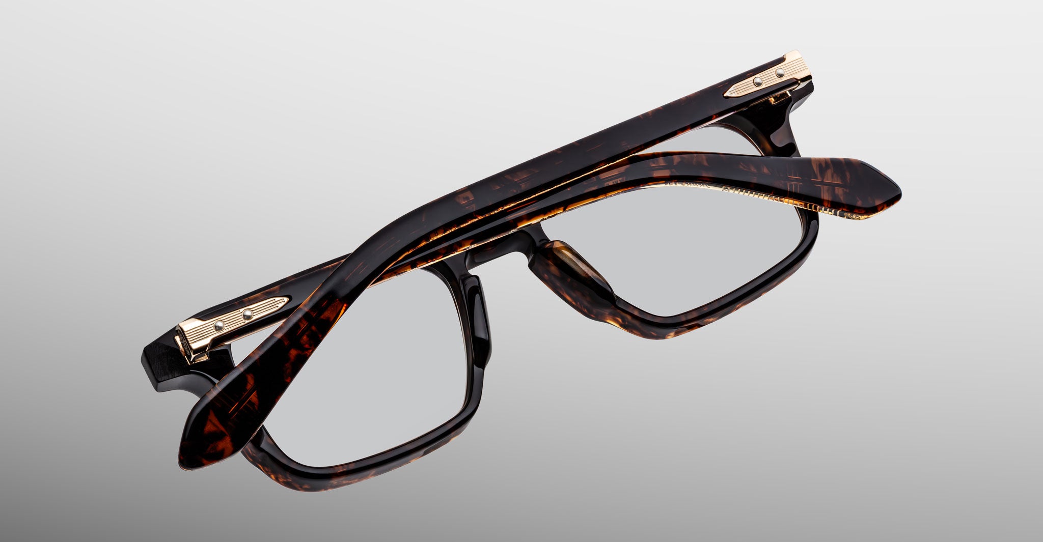 Jacques Marie Mage Moscova in Beau acetate optical frame, top-down angled view showcasing rectangular silhouette, rich tortoiseshell acetate, arrowhead front pins, and gold monoblock hinges with sculpted temples