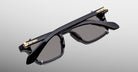 Jacques Marie Mage Moscova in Noir 15 acetate optical frame with Black clip-on, top-down angled view showcasing rectangular silhouette, polished black acetate, arrowhead front pins, gold monoblock hinges, and dark-tinted clip-on lenses