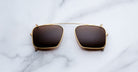 Jacques Marie Mage Moscova clip-on in Gold, front-facing view with rectangular brown-tinted lenses, slim gold metal frame, and bridge-mounted clip mechanism designed to attach seamlessly to Moscova optical frames
