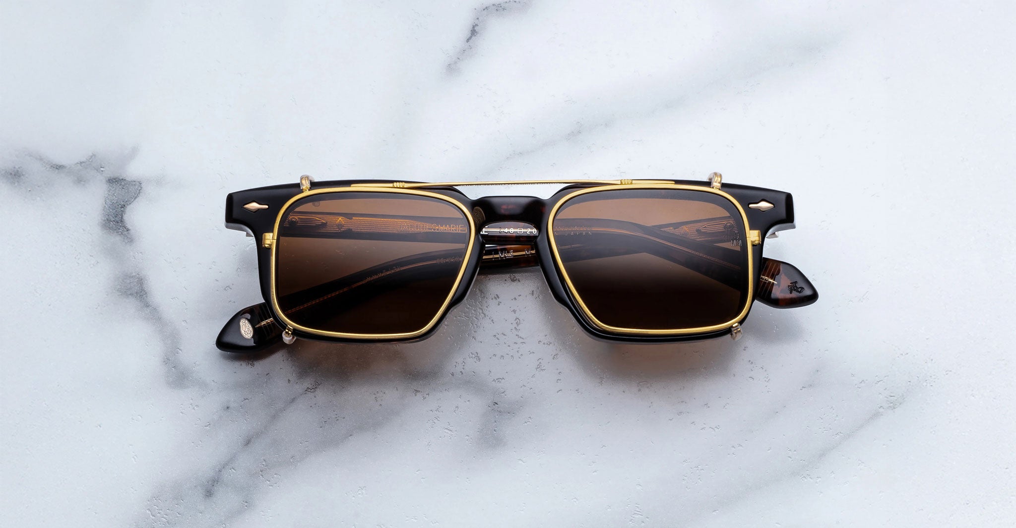 Jacques Marie Mage Moscova in Beau acetate optical frame with Gold clip-on, front-facing view featuring rectangular brown-tinted lenses, rich tortoiseshell acetate, signature arrowhead pins, and polished gold clip-on attachment across the bridge