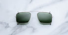 Jacques Marie Mage Moscova clip-on in Silver, front-facing view with rectangular green-tinted lenses, slim silver metal frame, and bridge-mounted clip mechanism designed to attach seamlessly to Moscova optical frames