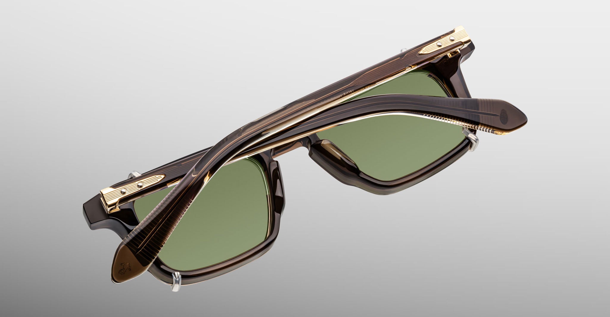 Jacques Marie Mage Moscova in London acetate optical frame with Silver clip-on, top-down angled view showcasing rectangular silhouette, translucent brown acetate, arrowhead front pins, gold monoblock hinges, and green-tinted clip-on lenses