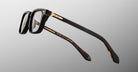 Jacques Marie Mage Moscova in Noir 15 acetate optical frame, side profile highlighting thick sculpted black acetate, gold hardware at the hinge, signature arrowhead pin, and tapered temples with exposed core wire and tortoiseshell interior detailing