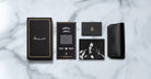 Jacques Marie Mage Louisville eyeglasses box, signature, info card, holder, folded photo, and case viewed from above.