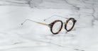 Jacques Marie Mage Norman round tortoiseshell eyeglasses with thin gold arms, shown from above.