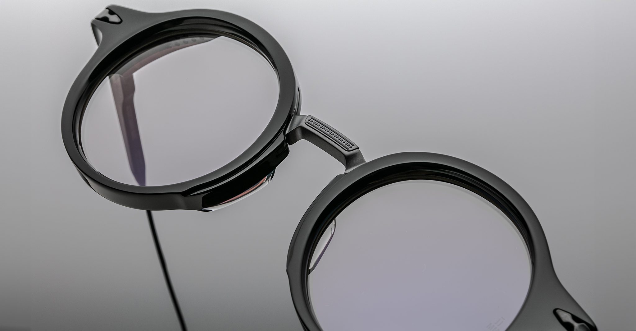 Close-up of Jacques Marie Mage Norman black round eyeglasses with clear lenses, front angle. Eyewear product shot.