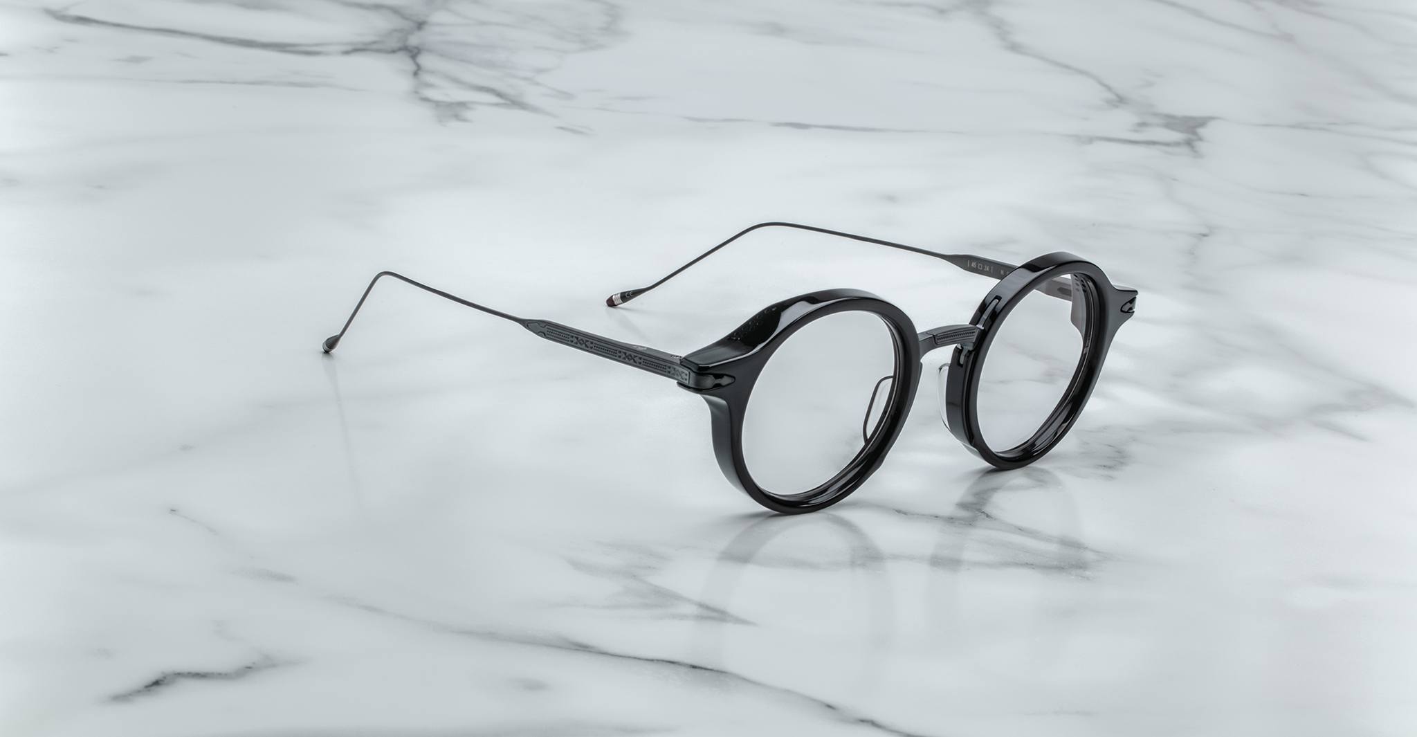 Jacques Marie Mage Norman eyeglasses, open and viewed from above, displayed on a flat white surface.