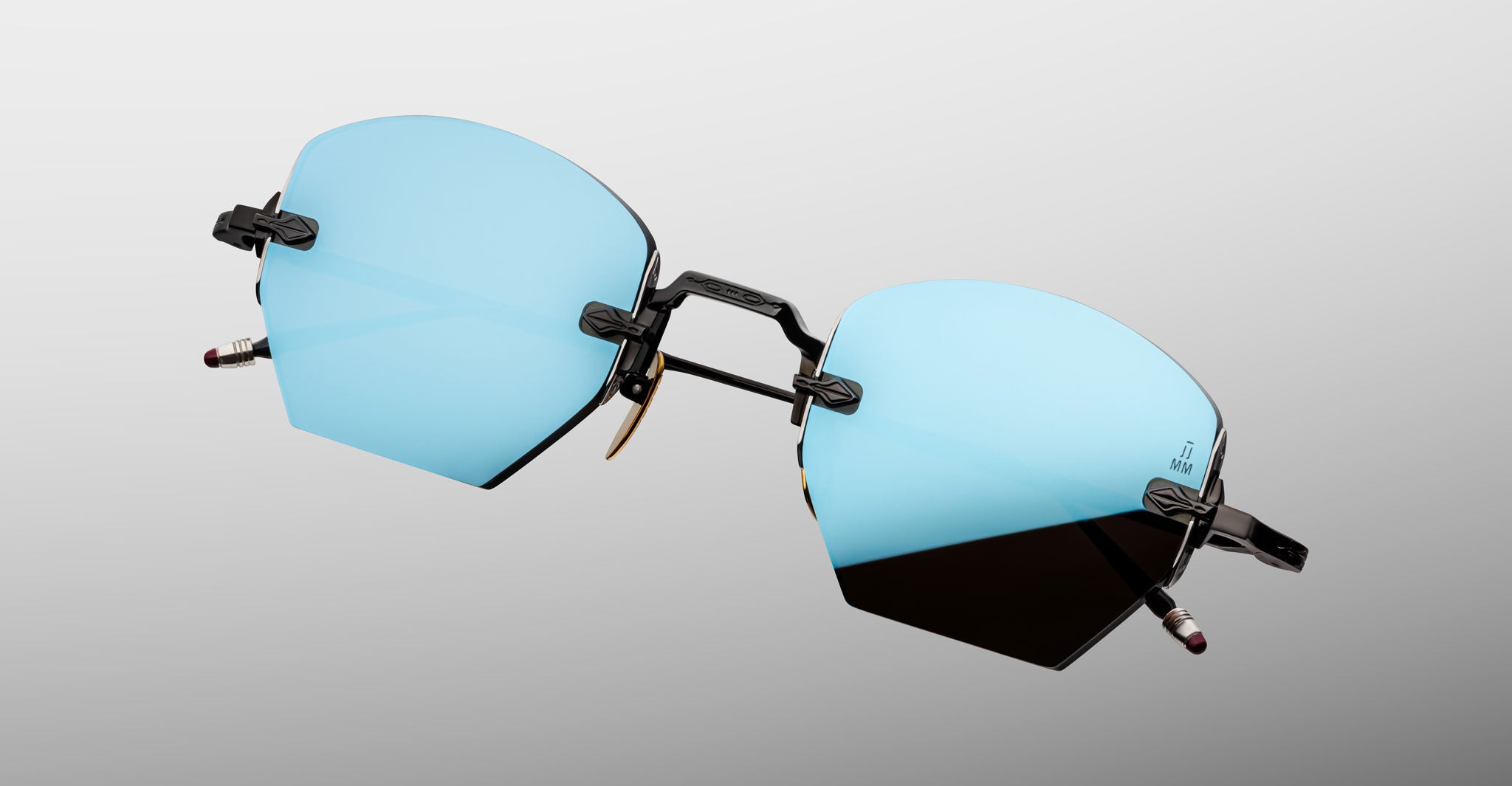 Jacques Marie Mage Oatman in Lagoon rimless sunglasses with blue-tinted geometric lenses and black arms, front angle view.