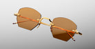 Jacques Marie Mage Oatman in Suntan sunglasses, gold metal frame with brown tinted lenses, shown from front angle.
