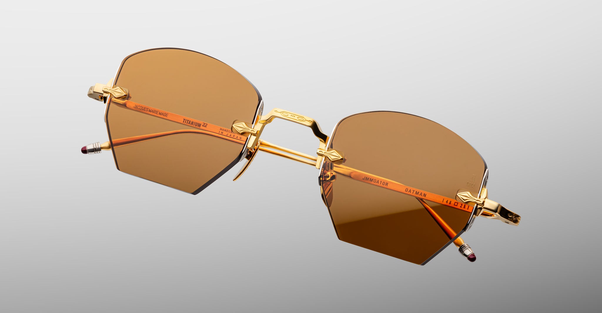 Jacques Marie Mage Oatman in Suntan sunglasses, gold metal frame with brown tinted lenses, shown from front angle.