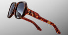 Close-up of Jacques Marie Mage Ocean Child oversized square sunglasses featuring a tortoiseshell pattern and dark lenses, set against a plain light gray background.