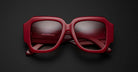 Jacques Marie Mage Gloria sunglasses featuring thick red frames and UV protection, shown from the front angle.